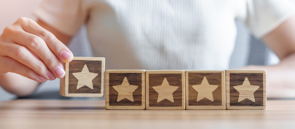 hand holding Star block. Customer choose rating for user reviews